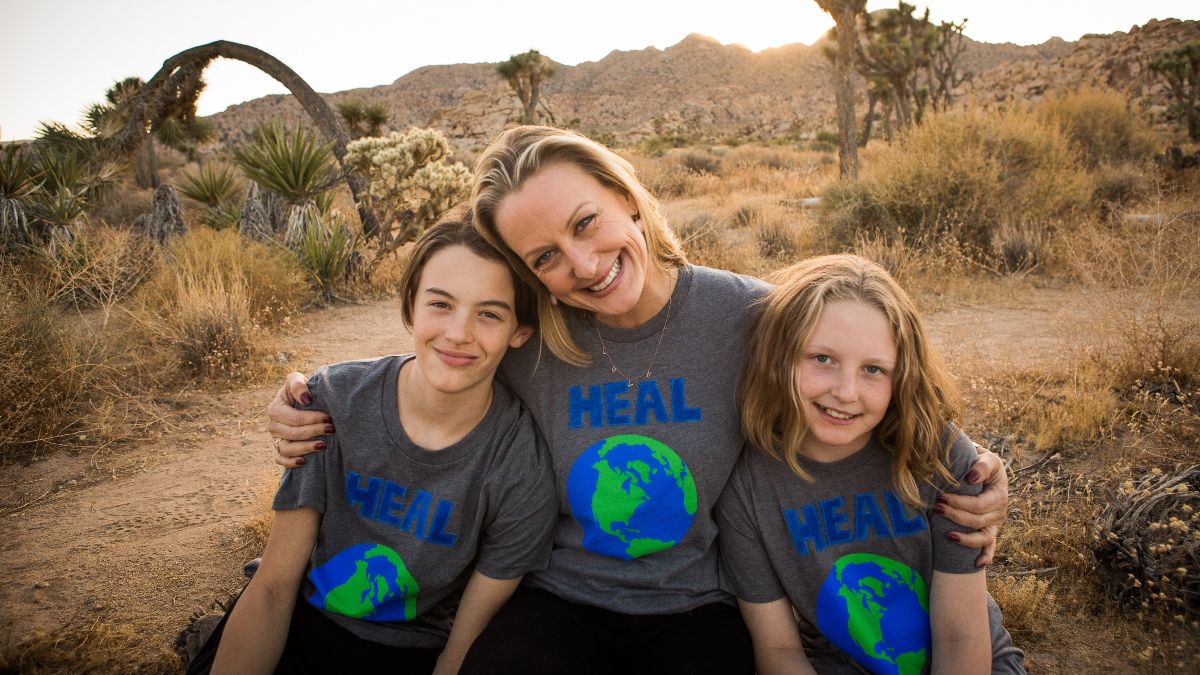 Elizabeth hugs her children as they all smile in the desert.