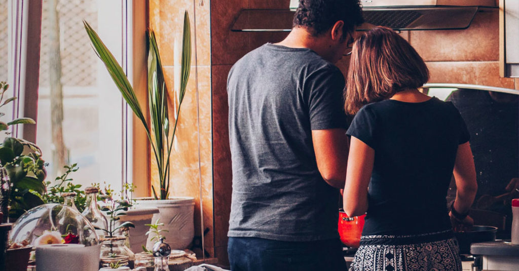 couple cooks together in the kitchen