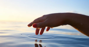 hand touching water