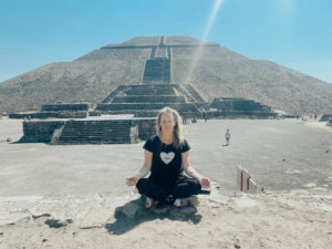 Elizabeth meditates in front of a pyramid