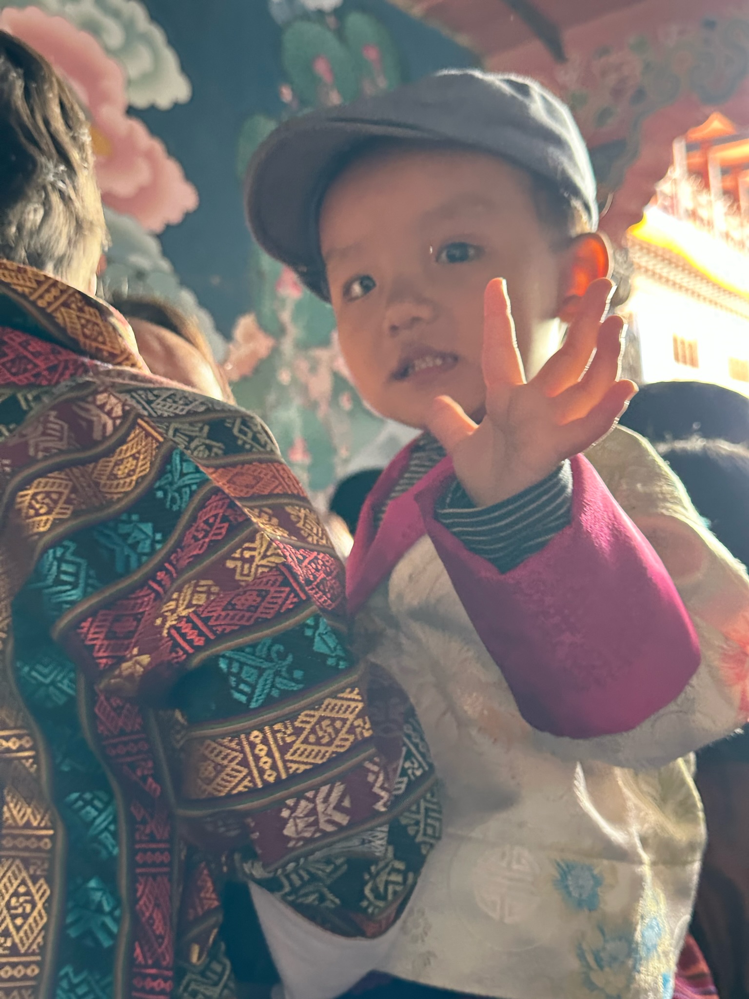 Child being held waving at the camera