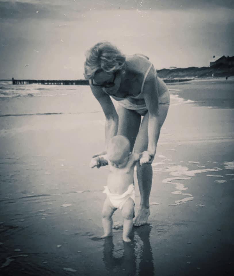 Elizabeth WInkler's mother playing with her on the beach as a infant