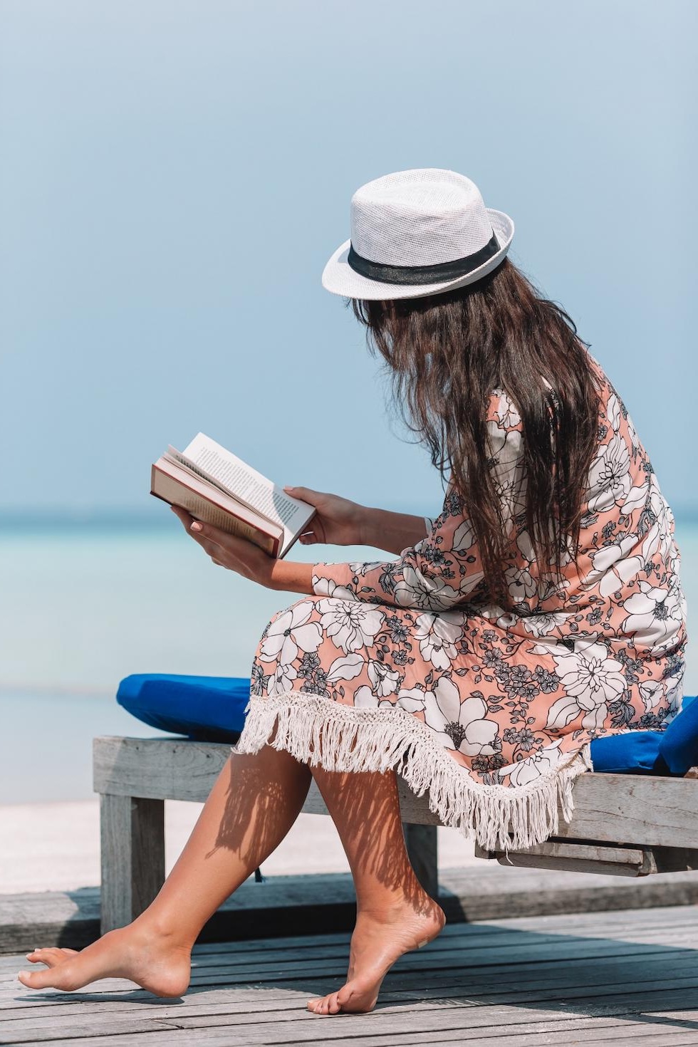 woman reading on beach